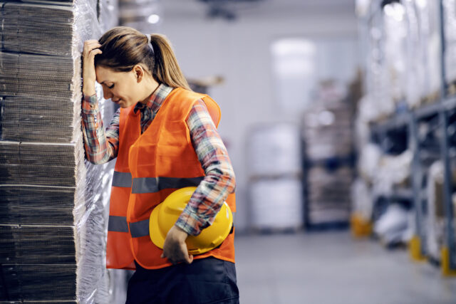 A female warehouse worker having troubles at warehouse.