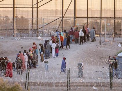 Immigrants wait to be transported and processed by U.S. Border Patrol officers at the U.S.