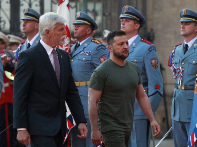 Czech President Petr Pavel (L) and Ukrainian President Volodymyr Zelensky review a militar