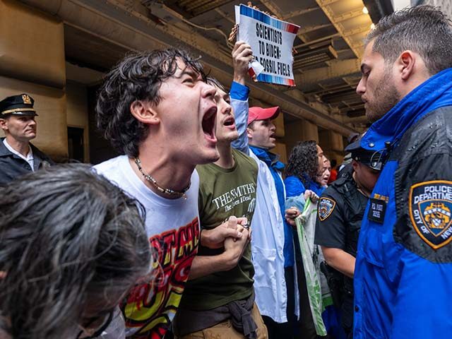 People involved in climate activism hold a demonstration in the Financial District of Manh