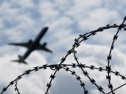 06 June 2024, Brandenburg, Schönefeld: An airplane takes off from BER Airport behind a fe