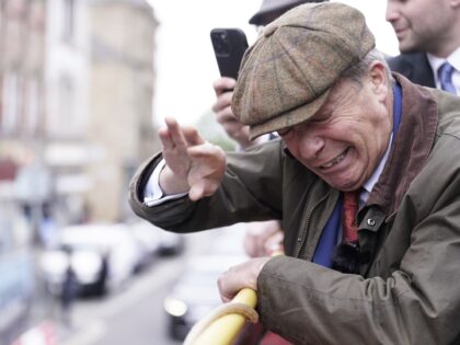 Reform UK leader Nigel Farage reacts after something is thrown towards him on the Reform U