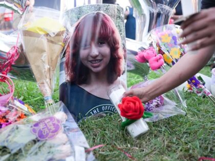 HOUSTON, TEXAS - JUNE 21: An attendee places a candle near a photo of 12-year-old Jocelyn