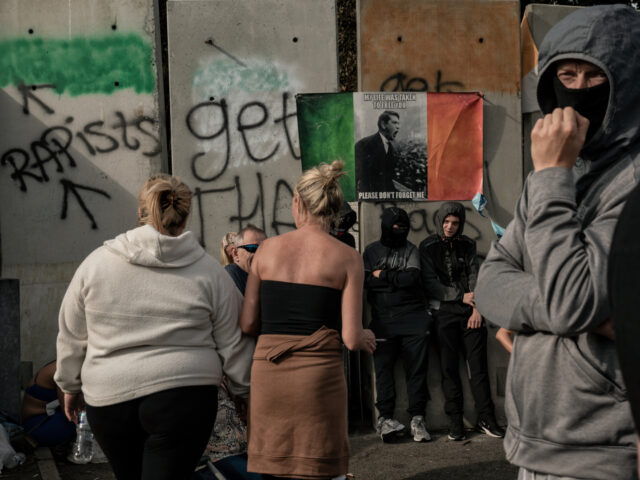 DUBLIN, IRELAND - JULY 19: Protesters stand in front of the former Crown Paints site durin