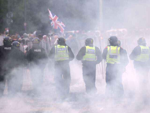 ROTHERHAM, ENGLAND - AUGUST 4: Riot police clash with anti-migration protesters outside of