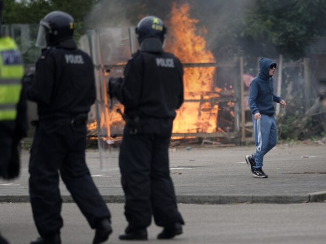 ROTHERHAM, ENGLAND - AUGUST 4: Riot police officers push back anti-migration protesters ou