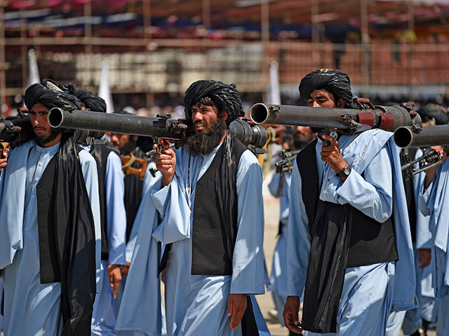 Taliban security personnel take part in a military parade to celebrate the third anniversa