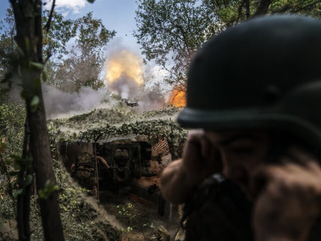 DONETSK OBLAST, UKRAINE - JULY 29: Ukrainian soldiers firing with D30 artillery at their f