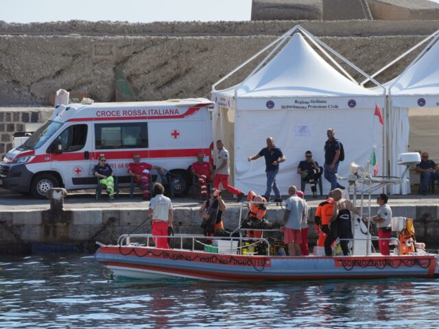 An Italian fire service dive team return to port on the fifth day of the search and recove