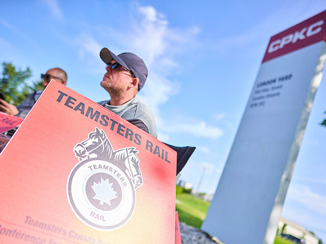 Canadian Pacific Kansas City (CPKC) rail workers stand on the picket line at the company's