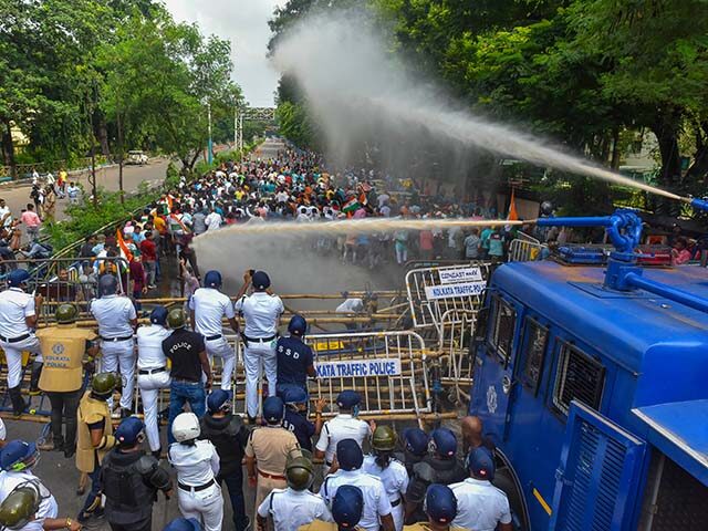 Police fire water cannons to disperse the crowd during a clash between police, citizens, a