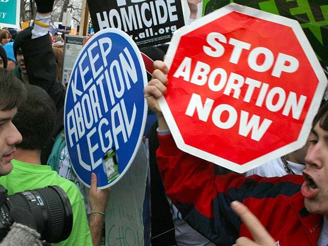 Pro-life demonstrators (R) confront pro-choice counterparts (L) 23 January 2006 in Washing