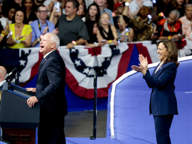 US Vice President Kamala Harris, right, applauds Tim Walz, governor of Minnesota and Democ