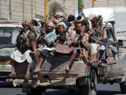 Armed Yemeni Shiite Huthi anti-government rebels sit in the back of a pick up truck as the