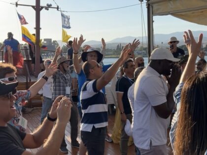 Christian Zionists from the U.S. and Ecuador worship aboard a boat on the Sea of Galilee,