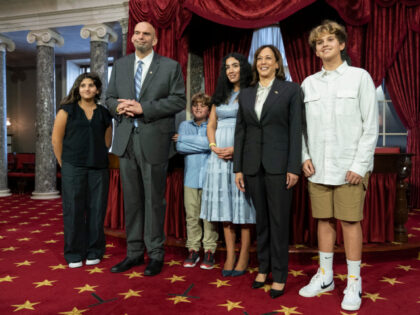 Vice President Kamala Harris, second from right, poses for a photograph with the family of