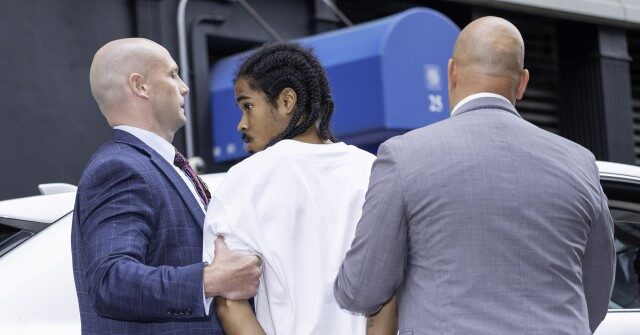 PHOTO: Alleged Cop-Shooter Parolee Flips the Bird in Holding Cell