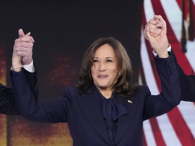 Democratic presidential nominee Vice President Kamala Harris holds the hands of second gen