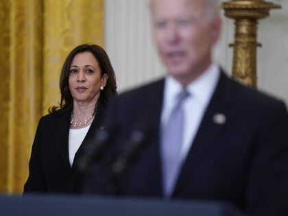 Vice President Kamala Harris listens as President Joe Biden speaks about distribution of C