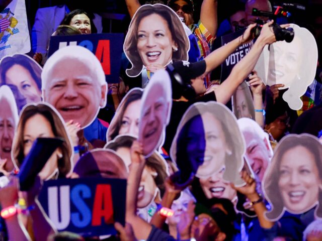 Delegates hold signs during a roll call vote during the Democratic National Convention (DN