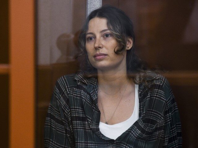 Ksenia Karelina, also known by the last name of Khavana, sits in a defendant's cage i