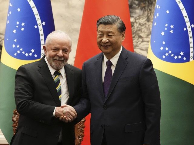 Brazilian President Luiz Inacio Lula da Silva, left, shakes hands with Chinese President X