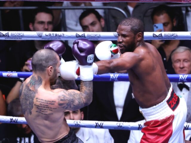 MEXICO CITY, MEXICO - AUGUST 24: John Gotti III recieves a Floyd Mayweather Jr left punch,