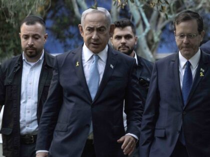 Israeli Prime Minister Benjamin Netanyahu, left, walks with President Isaac Herzog, center