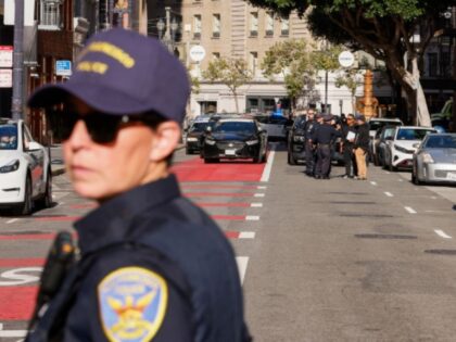 Police officers secure the area and investigate the scene of a shooting at Union Square in