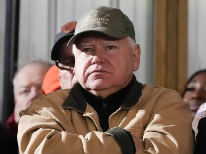 Minnesota Gov. Tim Walz listens as President Joe Biden speaks at Dutch Creek Farms in Nort