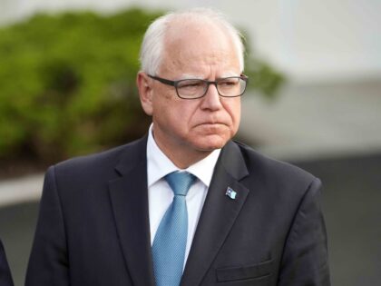 FILE - Minnesota Gov. Tim Walz listens after meeting with President Joe Biden, July 3, 202