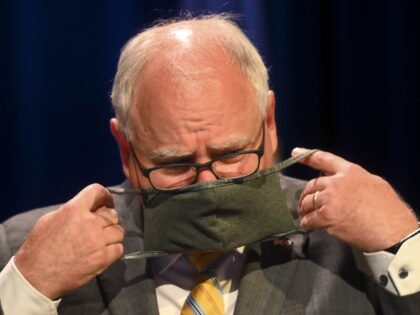 Minnesota Gov. Tim Walz put his face mask at the conclusion of a press conference Thursday