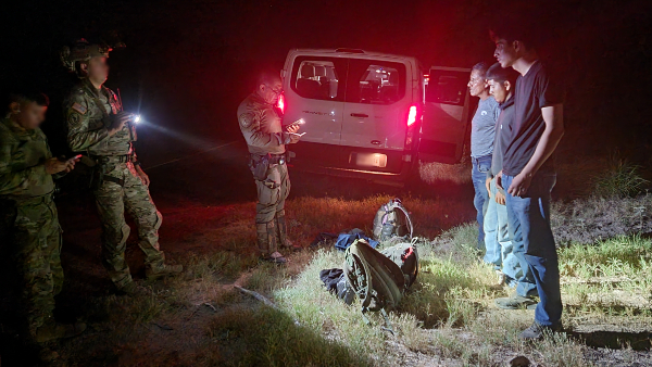 A DPS trooper reads the three arrested Mexican migrants their rights as they are placed under arrest. (Bob Price/Breitbart Texas)