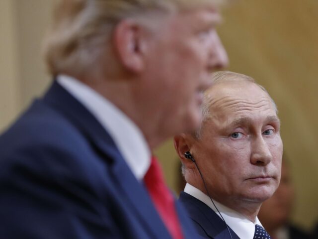 Russian President Vladimir Putin, right, looks over towards U.S. President Donald Trump, l