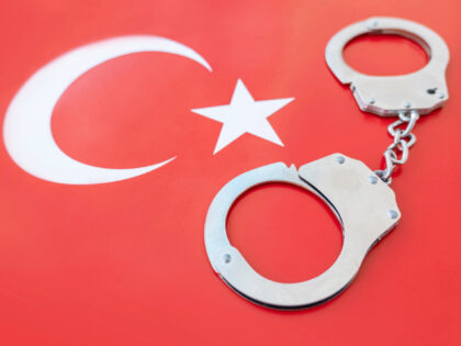 Turkey flag and police handcuffs. The concept of crime and offenses in the country. concep