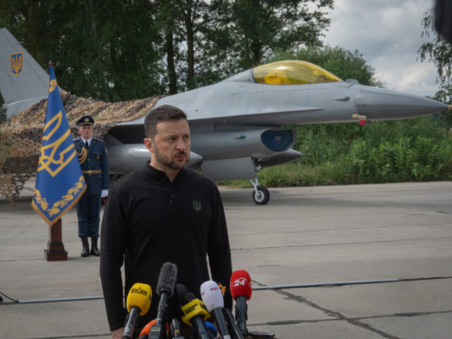 Ukraine's President Volodymyr Zelenskyy answers media questions standing against the backg