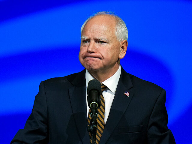 Democratic vice presidential nominee Minnesota Gov. Tim Walz reacts as he speaks at the Am