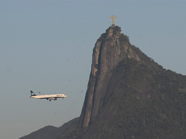 An Azul Brazilian Airlines plane flies past the 'Christ the Redeemer' statue whi