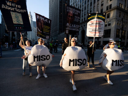 WASHINGTON - AUGUST 18: Demonstrators dressed as misoprostol tablets march in the "Let's C