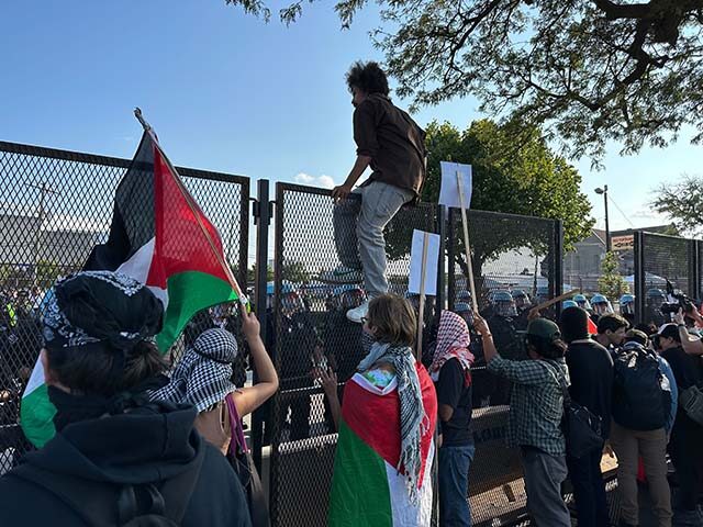 protester-climbing-fence-DNC (1)