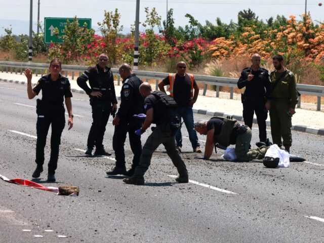 Israeli police check the site of a Hezbollah explosive drone attack near the northern city