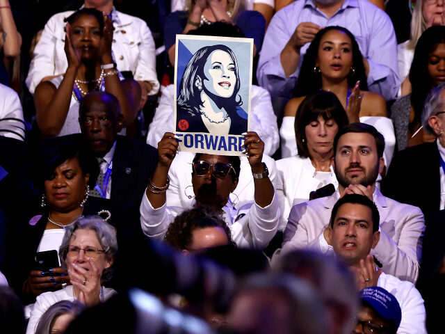 An attendee holds a poster of Democratic presidential candidate, U.S. Vice President Kamal