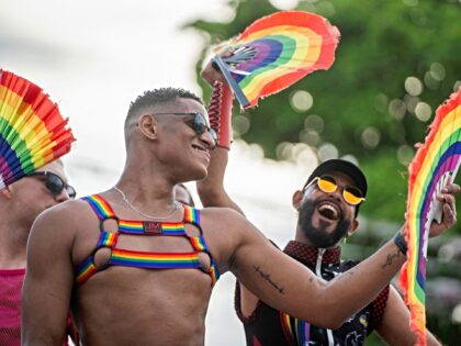 Activists of the Lesbian, Gay, Bisexual, and Transgender (LGBT+) community hold rainbow-co