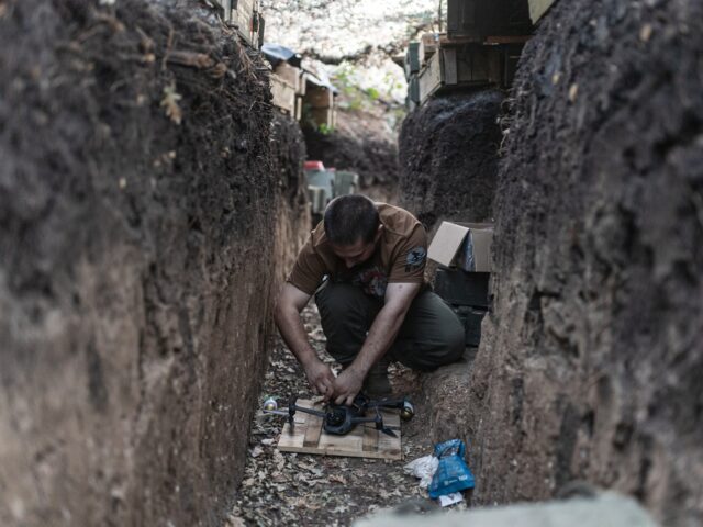 DONETSK OBLAST, UKRAINE - AUGUST 10: Ukrainian soldier prepares a drone in a shelter in th