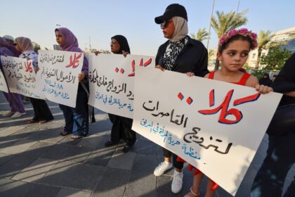 Activists in Baghdad's Tahrir Square demonstrate against female child marriage on July 28,