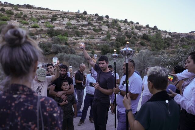 Activists try to reach a land confiscated by Israeli settlers in the al-Makhrur area, near