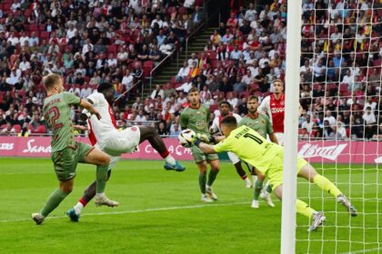 Ajax striker Brian Brobbey (2L) tries to poke the ball past Jagiellonia goalie Mateusz Skr