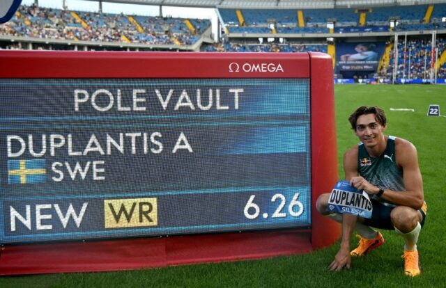 Armand Duplantis poses next to a board displaying his new 6.26-metre world record at the S