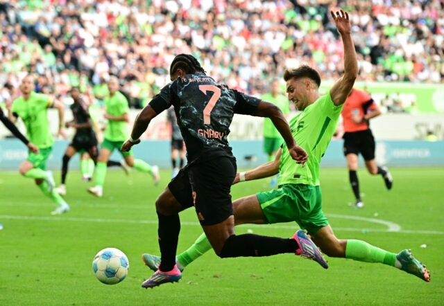 Bayern's Serge Gnabry takes on Wolfsburg defender Kilian Fischer