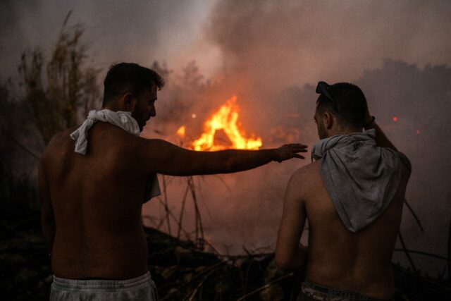 The blaze first broke out Sunday afternoon in the town of Varnavas, northeast of Athens